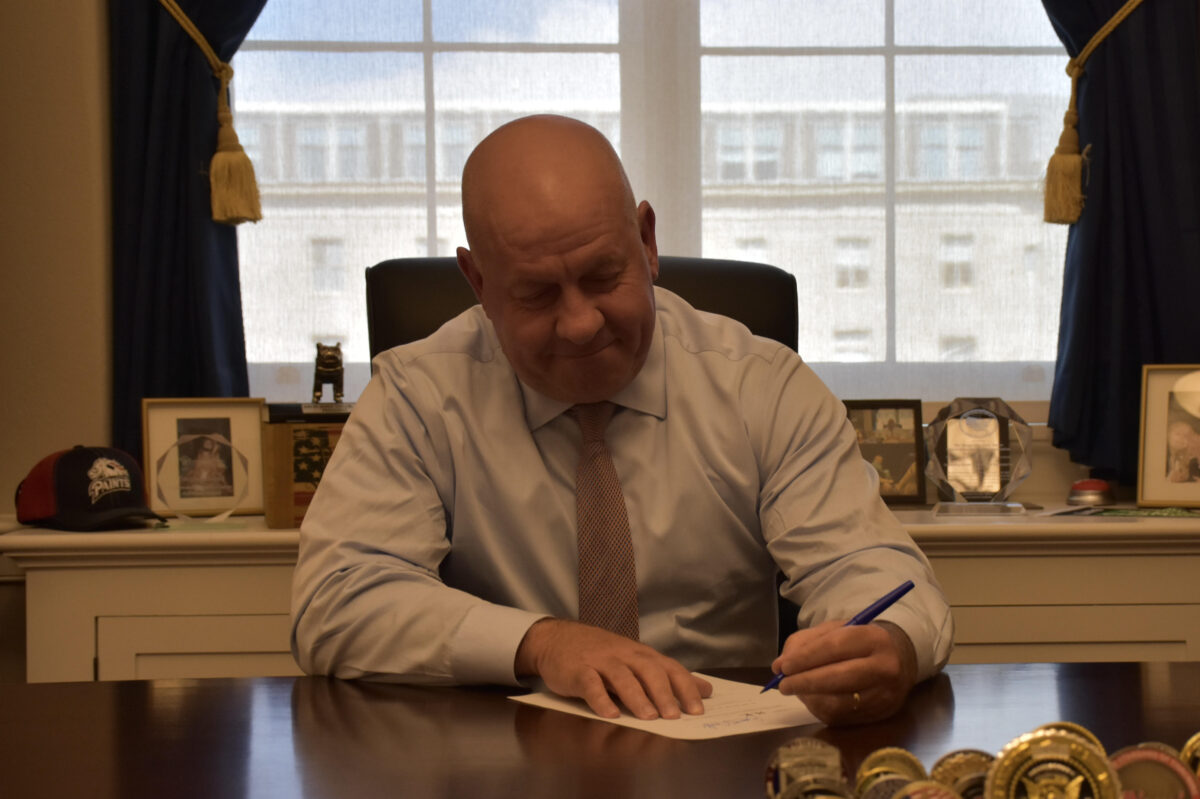 Congressman Dave Taylor signs his support onto a bill that would uncover SNAP fraud.