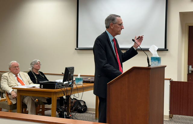Journalist Chris Hicks stands at a podium inside the Clermont County Court of Common Pleas on Tuesday. Behind him sits local attorney Scott Croswell, who was representing public official and magistrate Jessica Little.