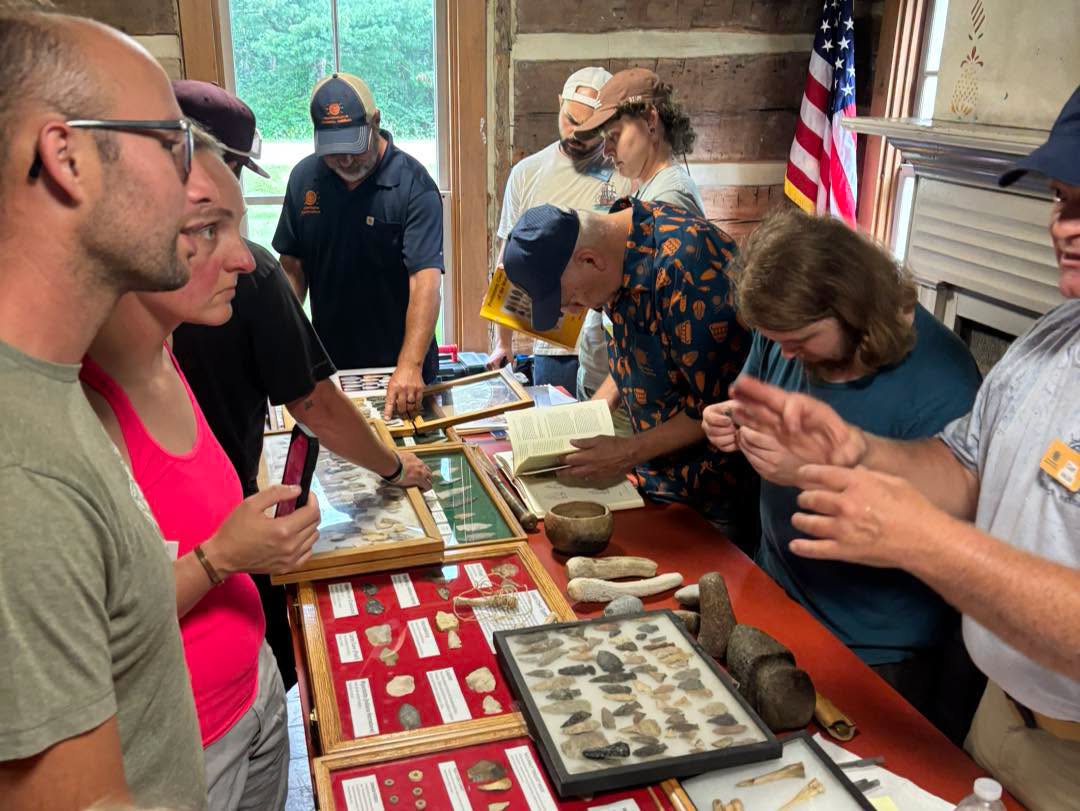 Visitors examine artifacts at Hartman Cabin evaluation event
