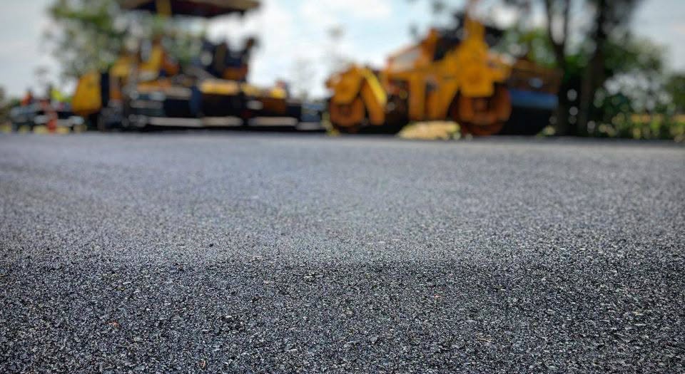 Crews pave a road as part of a resurfacing project