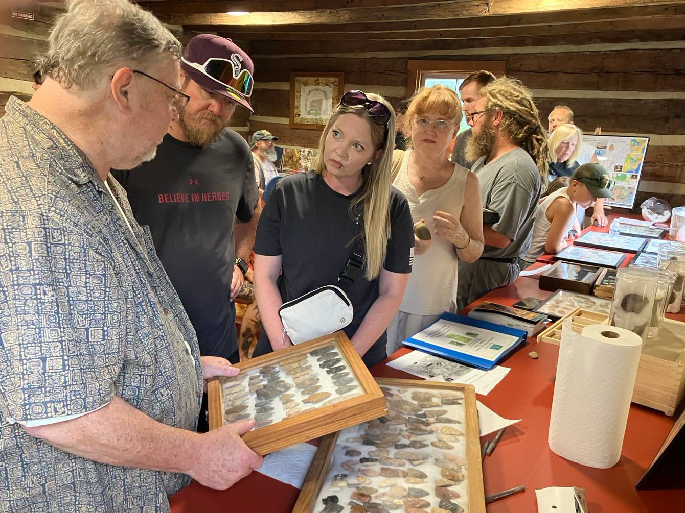 Guests examine an arrowhead collection at Hartman Cabin