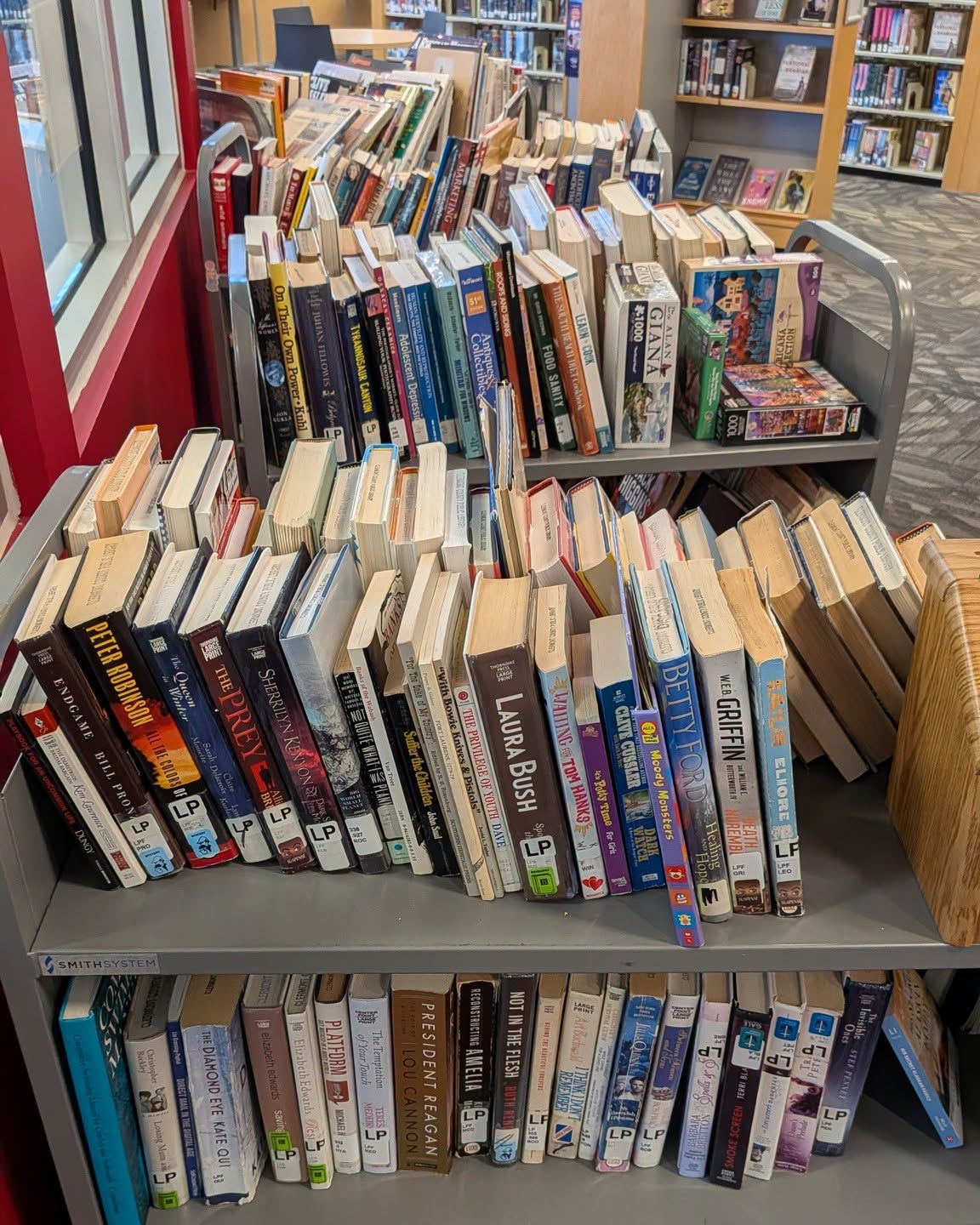 A cart of used books awaits shoppers at a Clermont County library branch