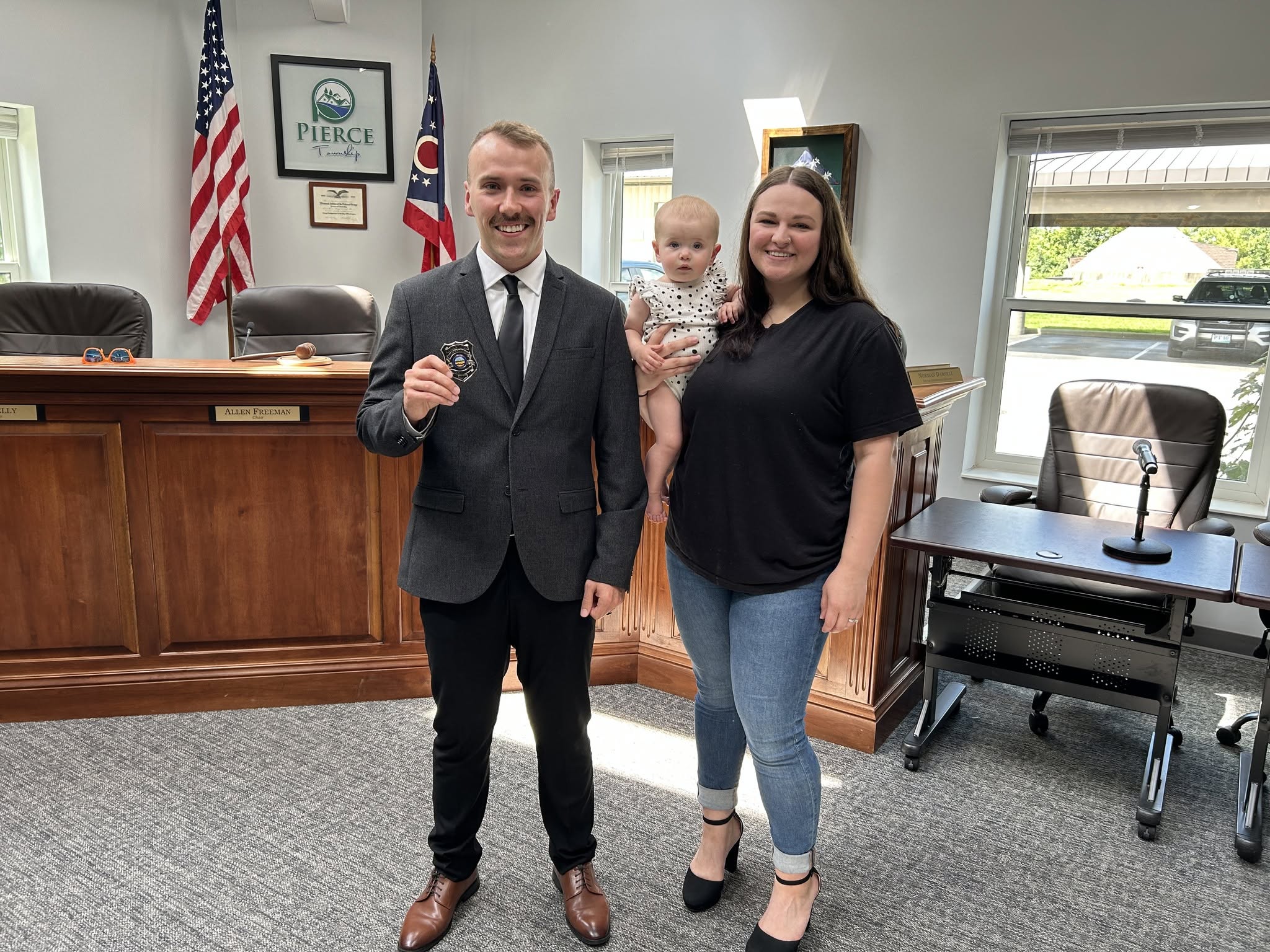 Officer Dakota Gullett holds his new badge alongside his family