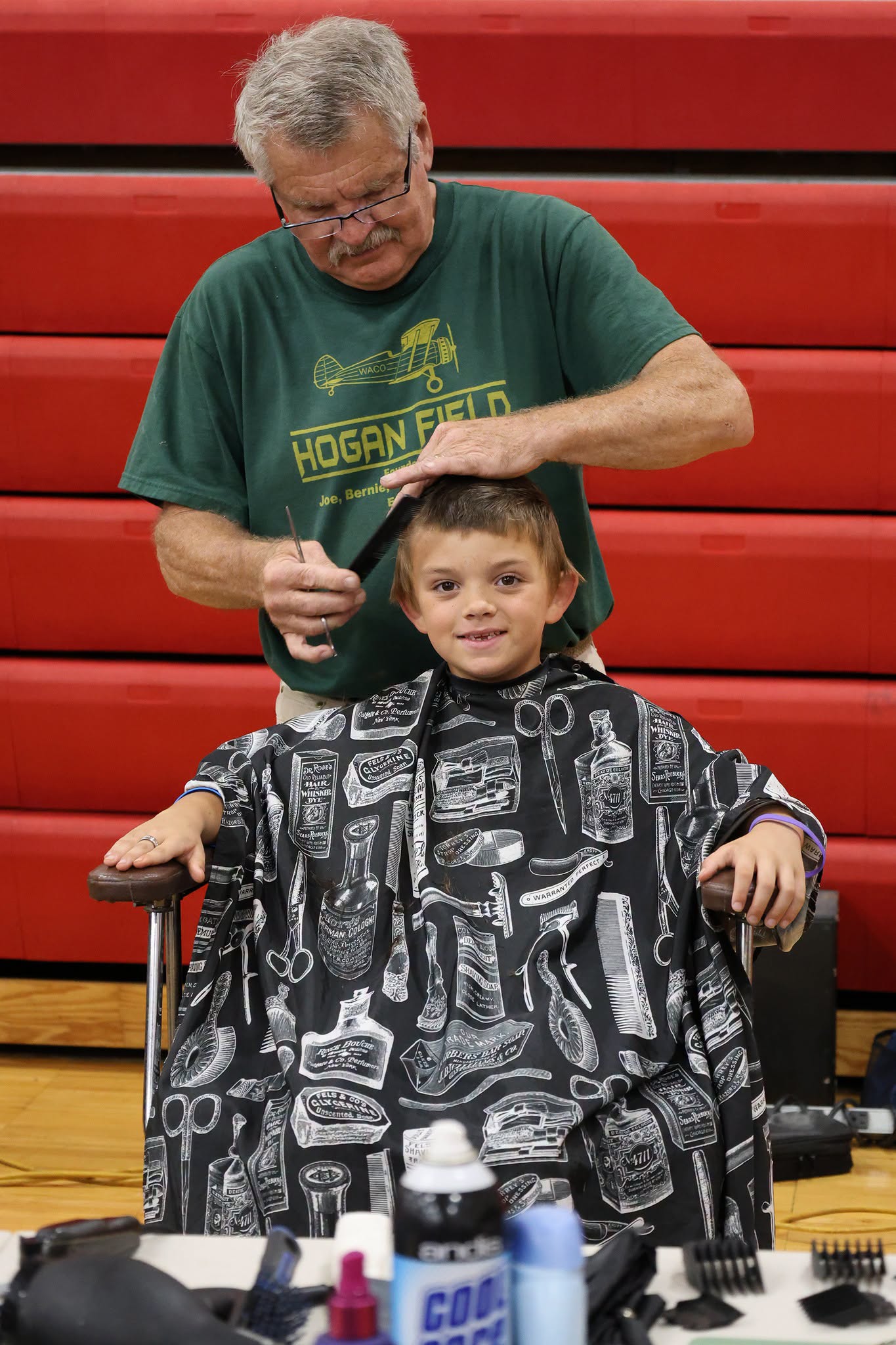 Volunteer barber gives a Goshen student a free haircut at Ready Fest