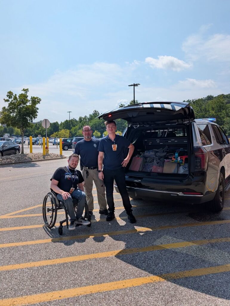 Milford police load a cruiser with donated school supplies