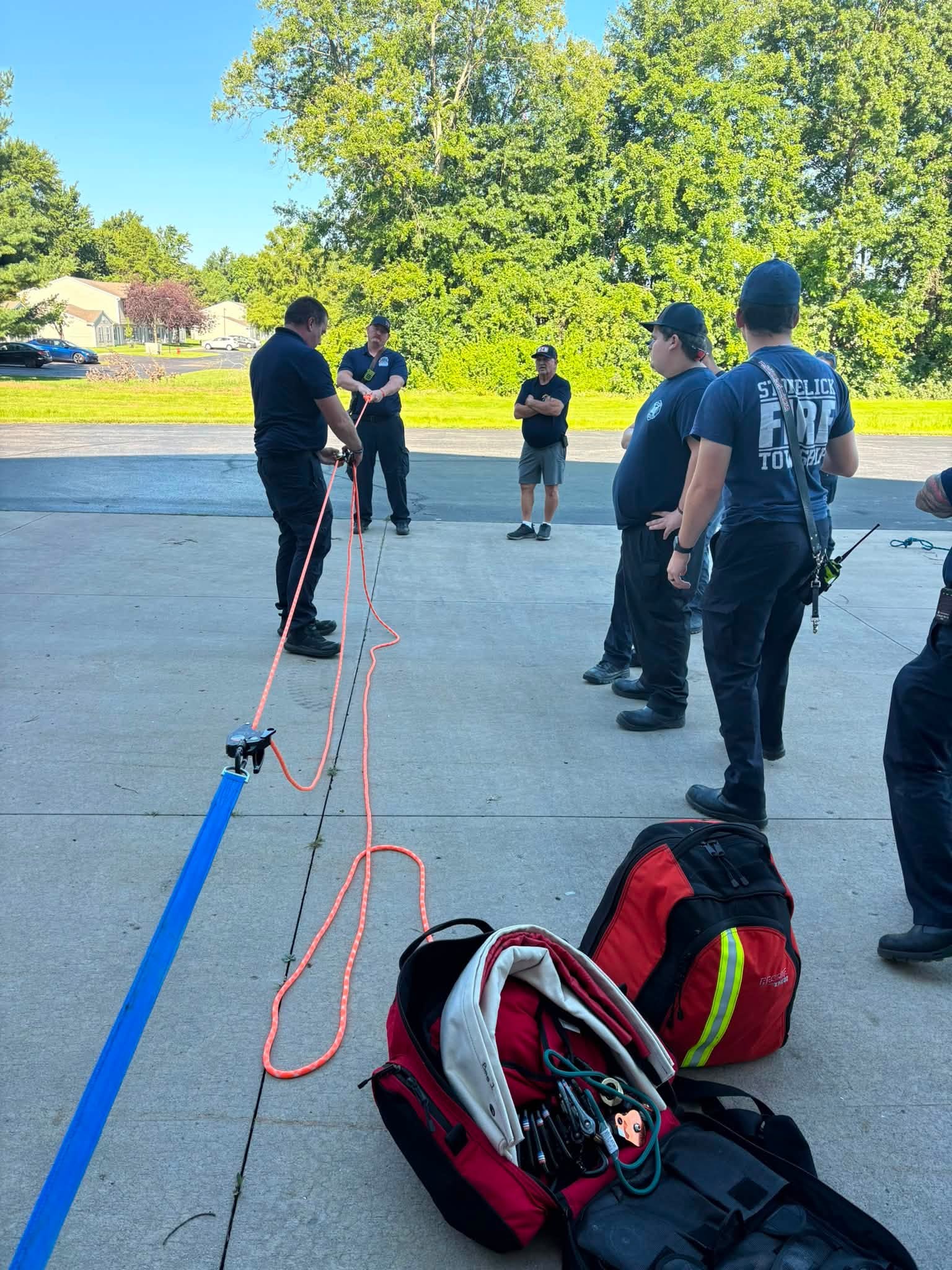 Firefighters set up a rope hauling system during joint rescue training