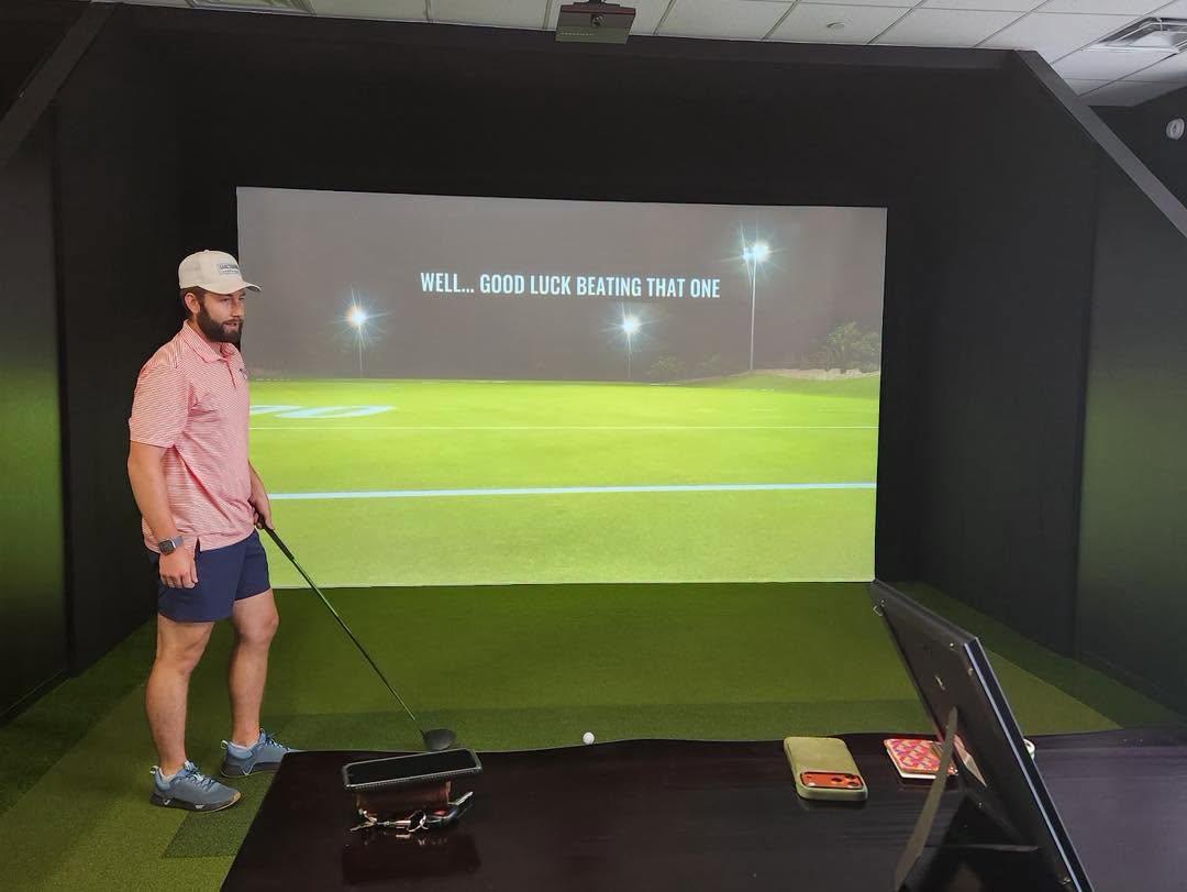 A golfer uses a Trackman simulator at Tee Shot Indoor Golf