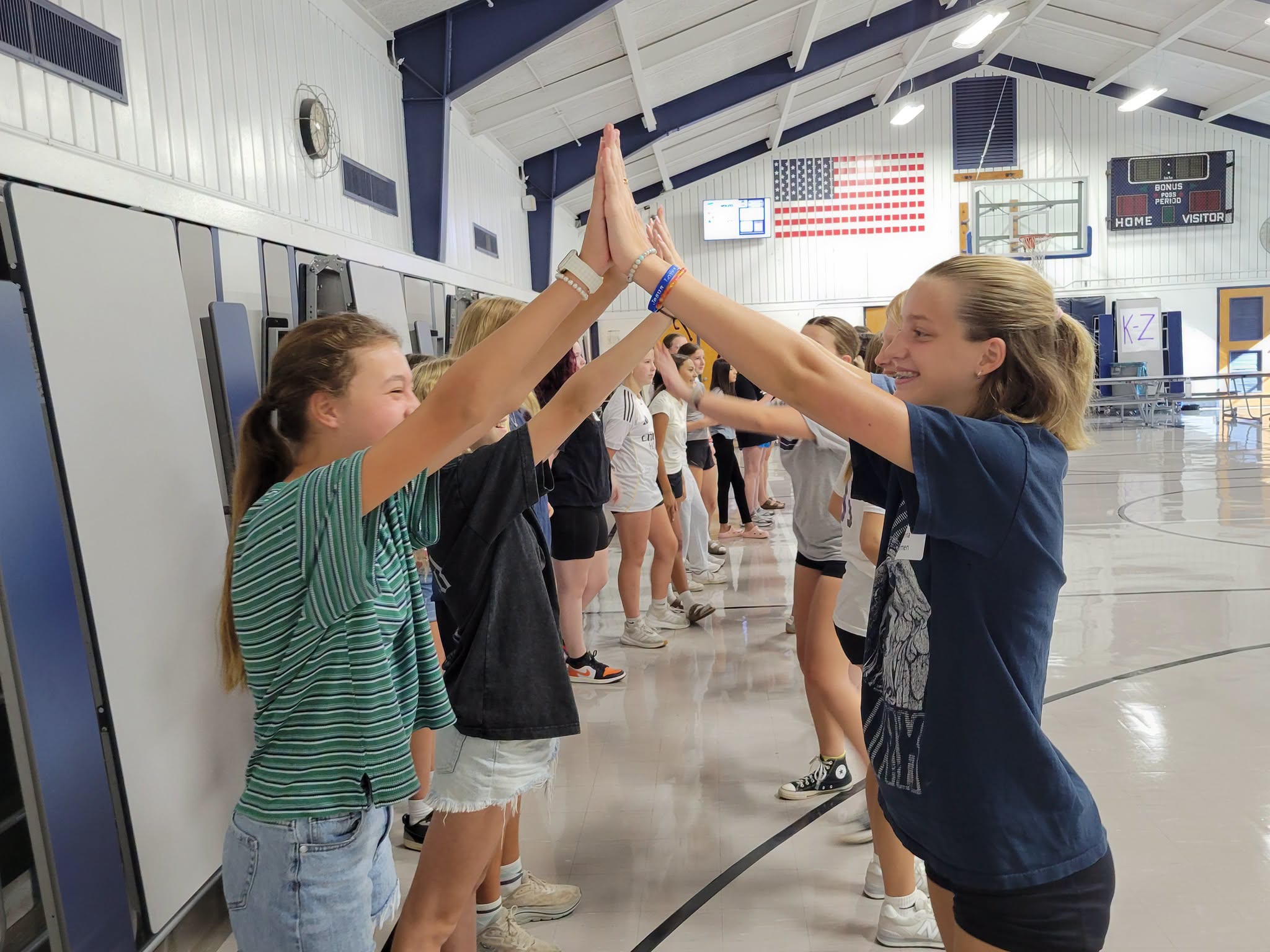WEB Leaders high-five sixth graders during orientation