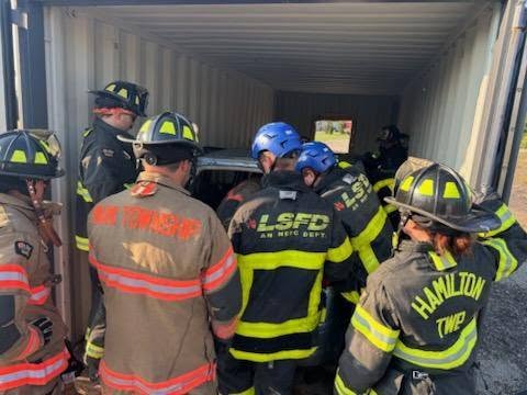 Firefighters from multiple departments train together in a rescue container