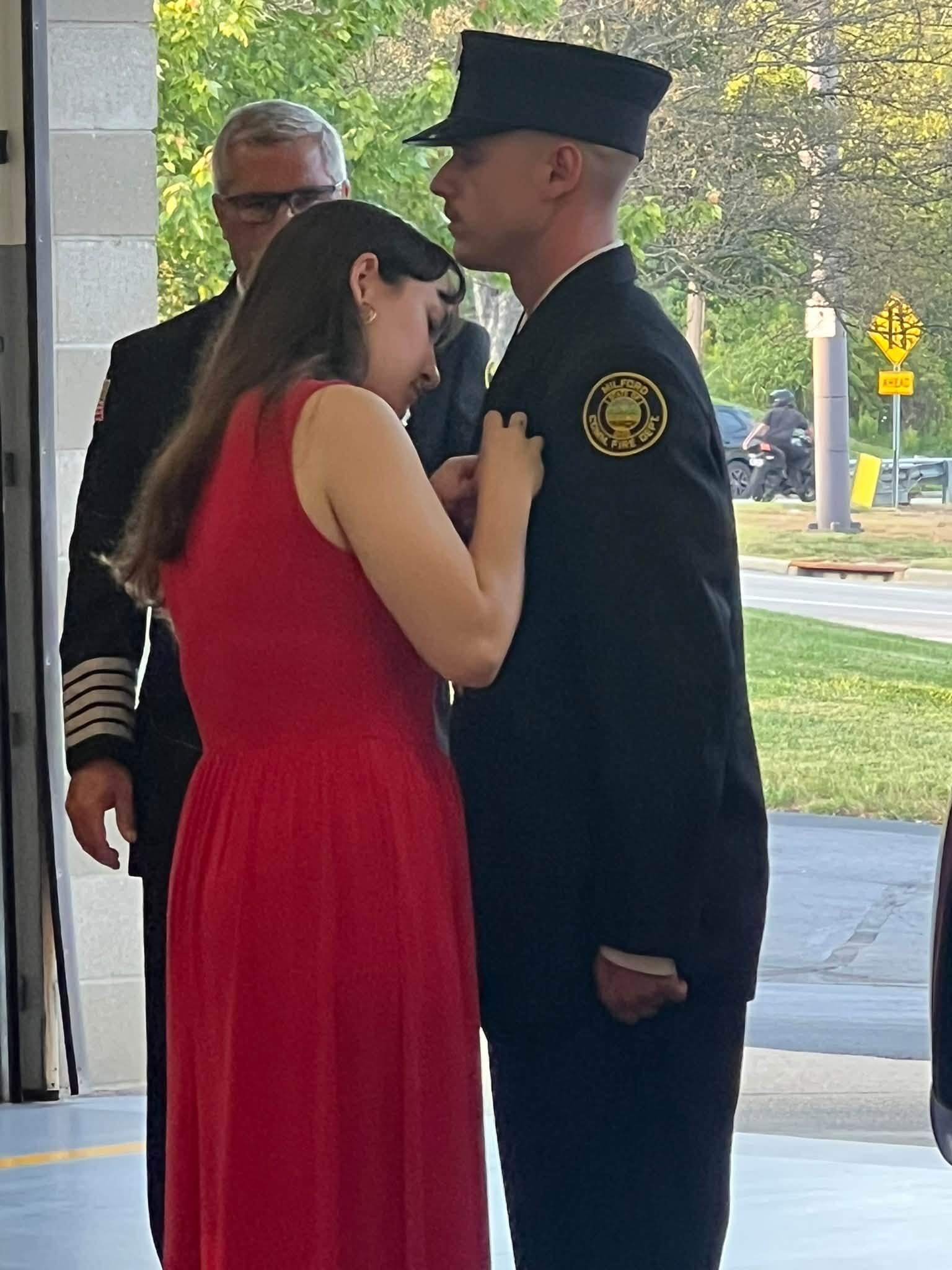 Kaiden Hartness has his badge pinned at Milford fire ceremony