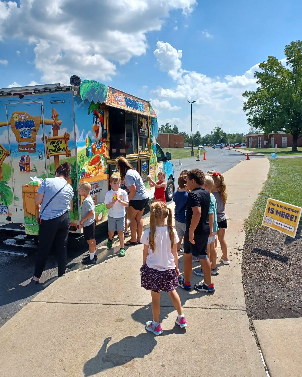 Students line up at the Kona Ice truck at Marr/Cook Elementary