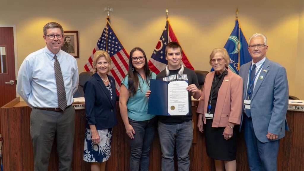 Clermont County commissioners and Clermont DD staff pose with Deklan Montes holding a signed proclamation
