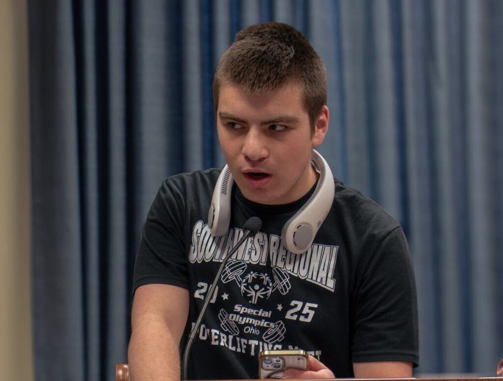 Deklan Montes speaks into a microphone at a Clermont County commissioners meeting