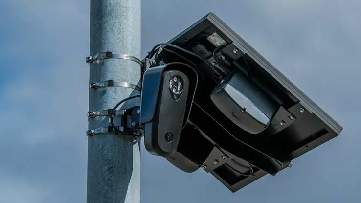 A Flock Safety license plate reader camera mounted on a utility pole