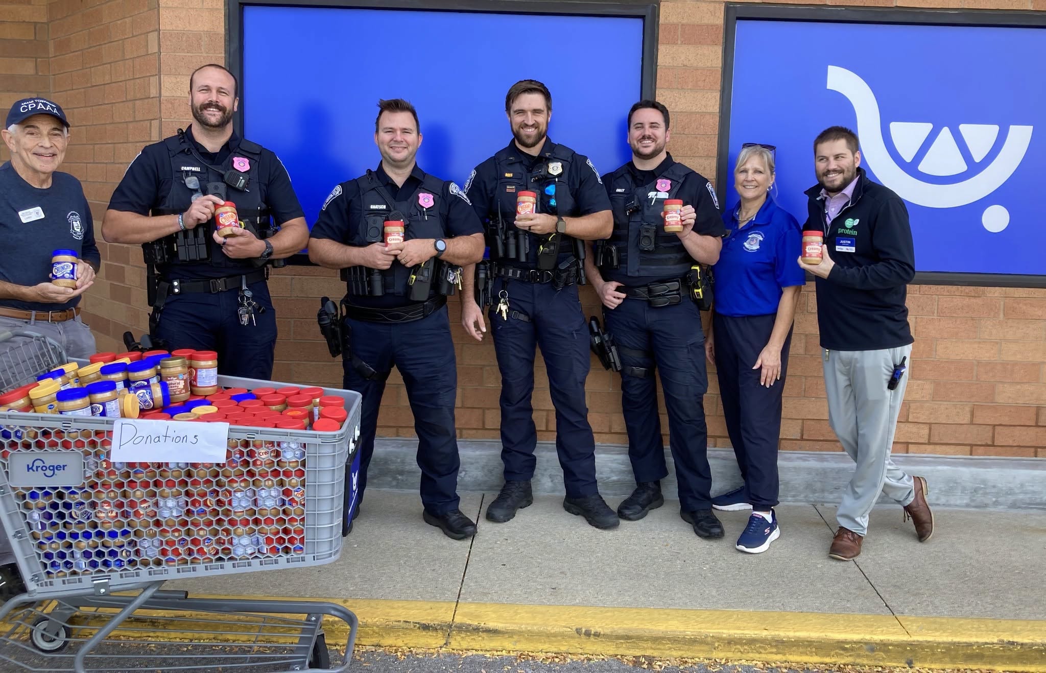 Miami Township officers and volunteers collect peanut butter donations at Kroger