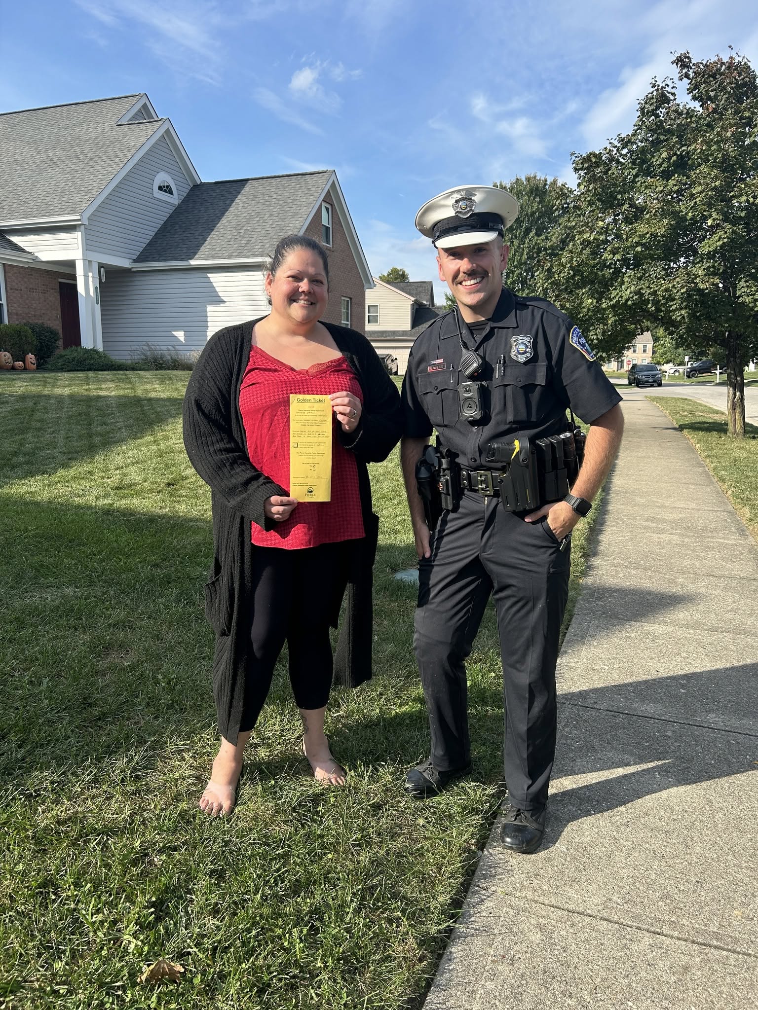 A Pierce Township resident holds her Golden Ticket award