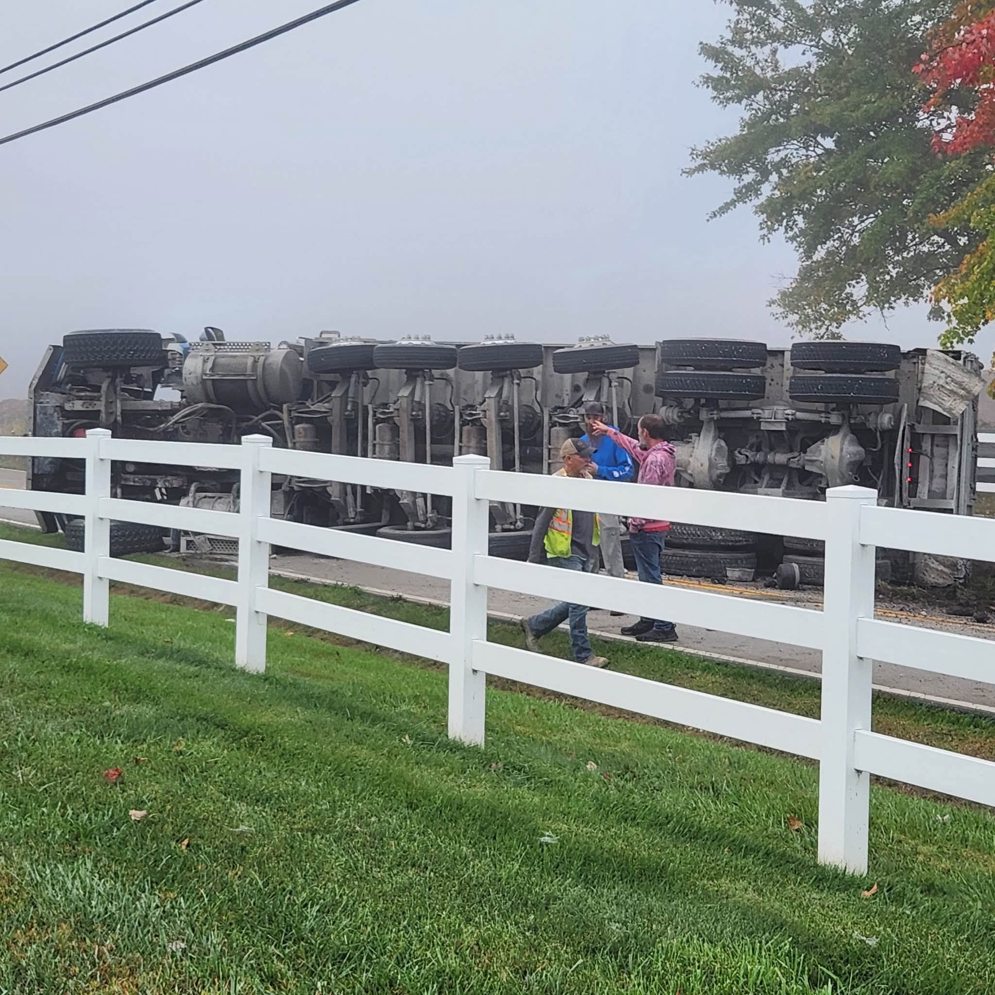 Crews assess the overturned tractor-trailer on Clough Pike