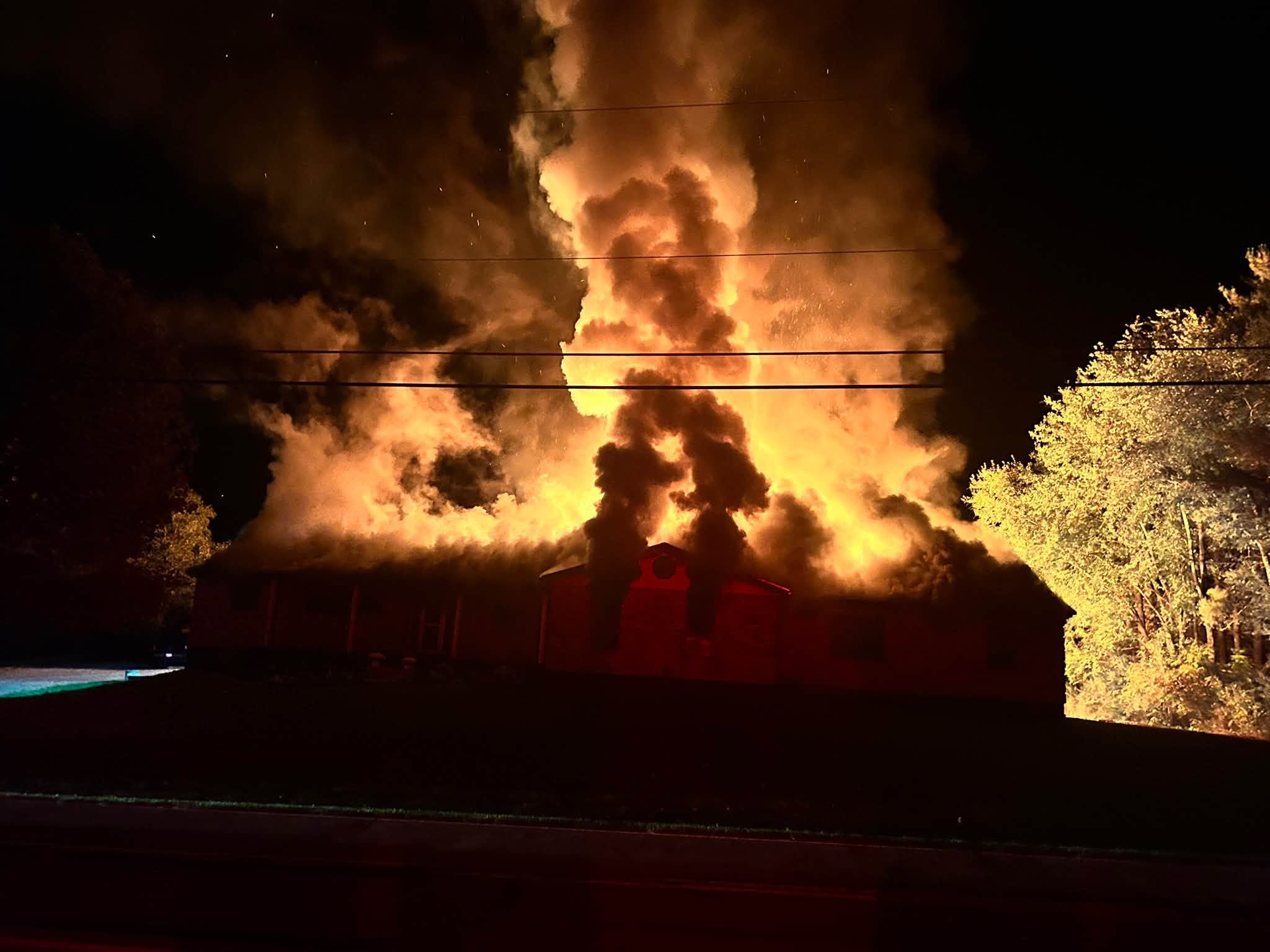 Flames engulf a structure during an overnight fire in Wayne Township